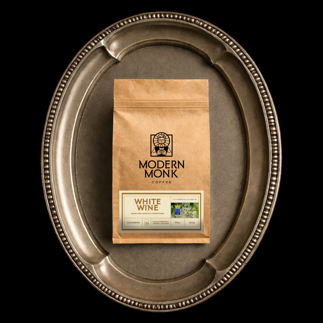 Modern Monk White Wine on a silver tray against a black background