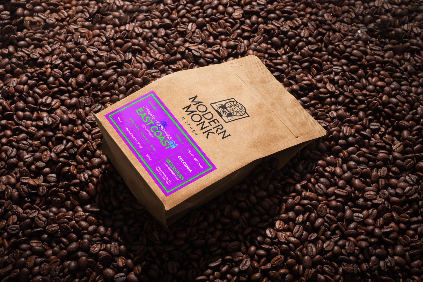 Coffee package with a purple label on a bed of coffee beans