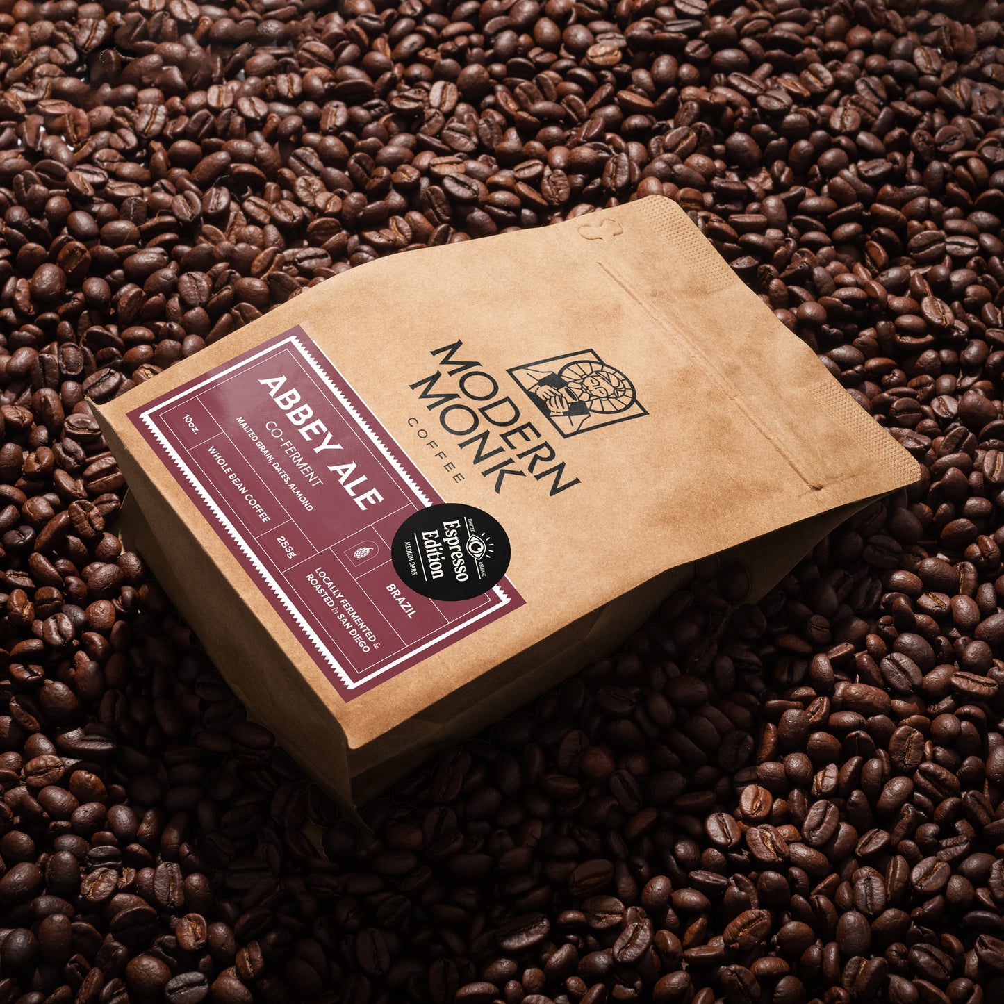 Modern Monk Abbey Ale package on a bed of coffee beans