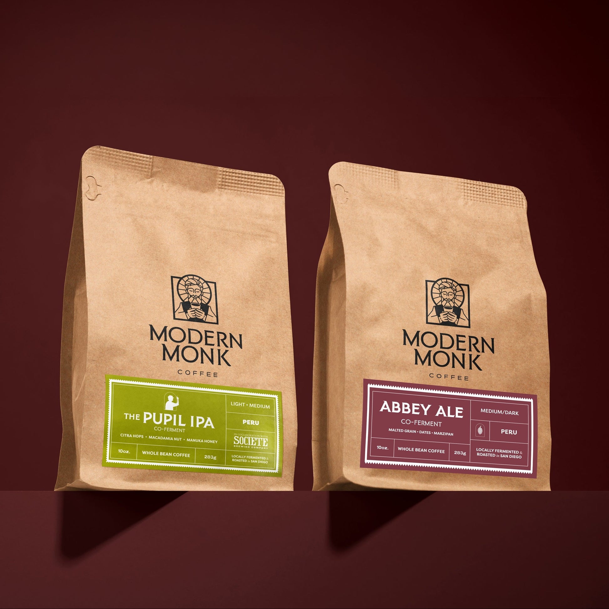 Two brown paper bags with 'Modern Monk' branding on a dark red background