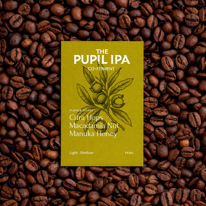 Yellow beer label on a bed of coffee beans