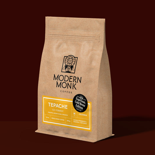 Brown coffee bag with 'Modern Monk Coffee' branding on a dark red background